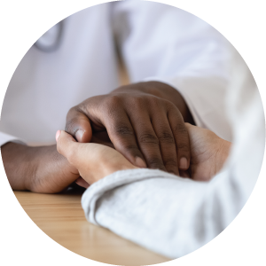 Female patient holding hands of black male doctor. Concept of compassion.