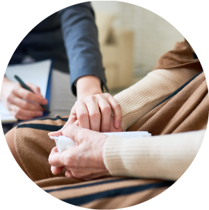 Clinician compassionately holding client's hand.