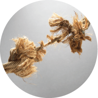 A length of rope almost broken with the strain.