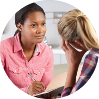 Teenage girl speaking to female doctor.